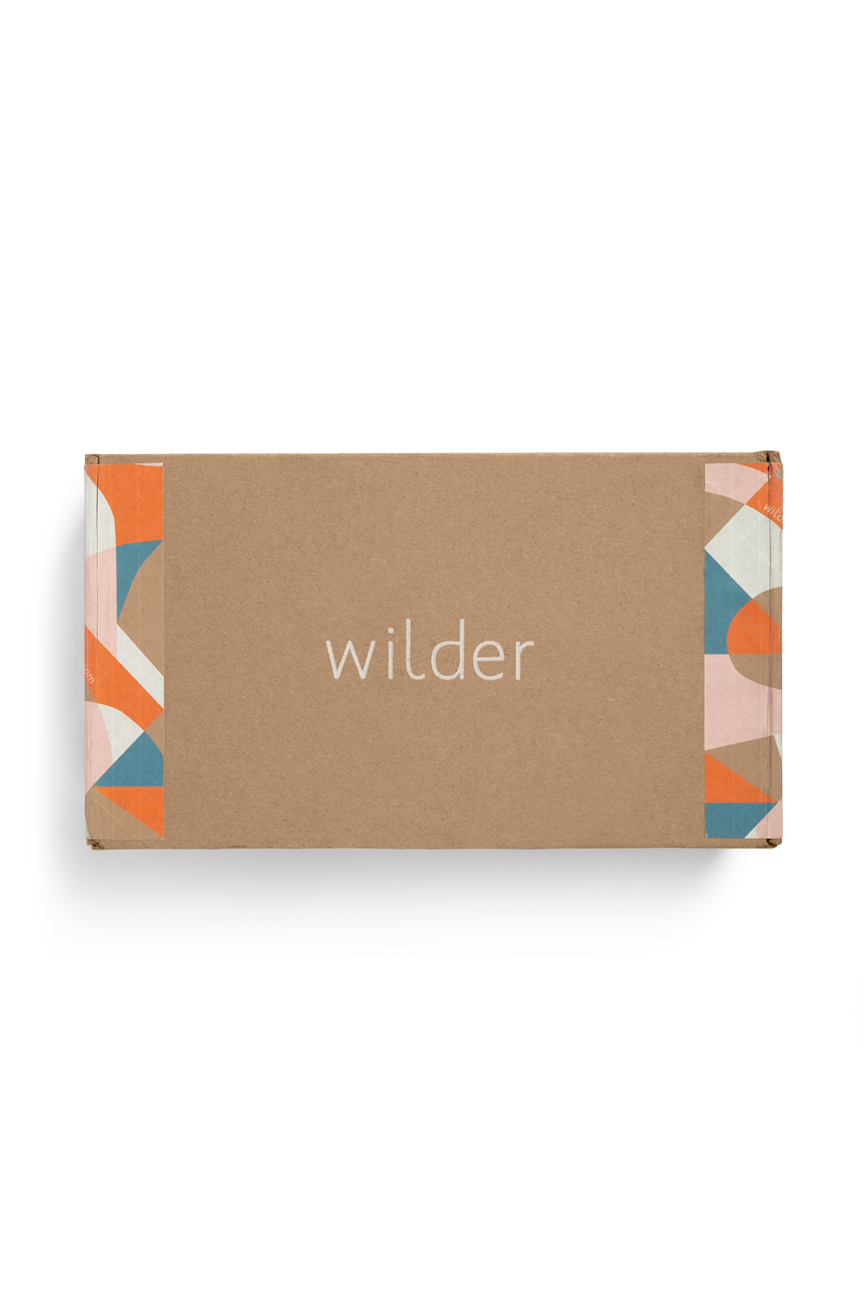 Custom roll end tuck front corrugated mailer box for Wilder with roll end base, tuck front lid, cherry locks, dust flaps. Flexography on natural kraft liner.