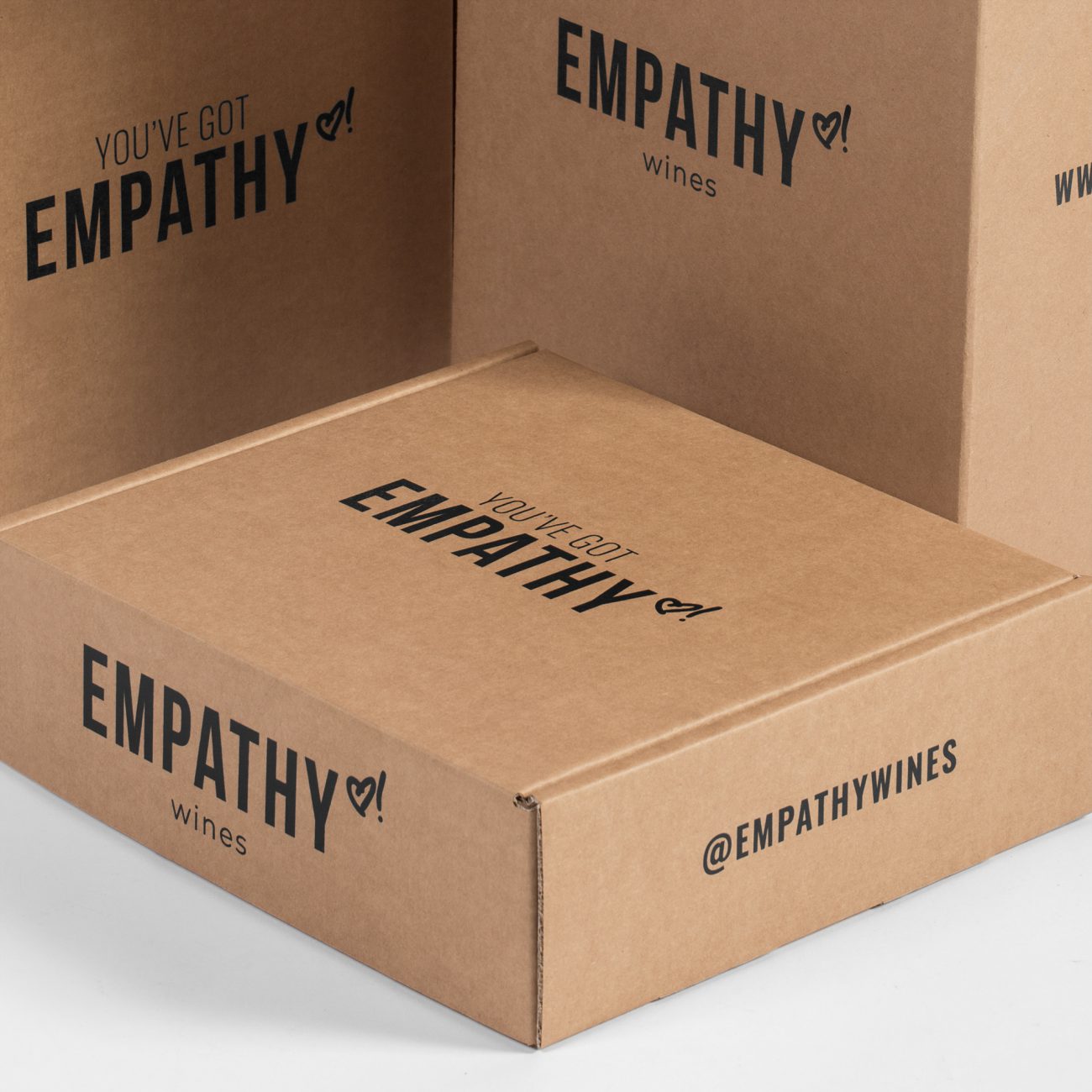 Custom roll end tuck front corrugated mailer box for Empathy Wines with thumb notch, roll end base, tuck front lid. Flexography on natural kraft liner.